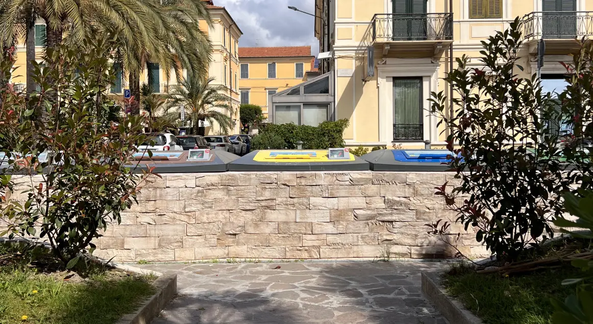 Semi Underground containers with stone cladding in a garden in Diano Marina