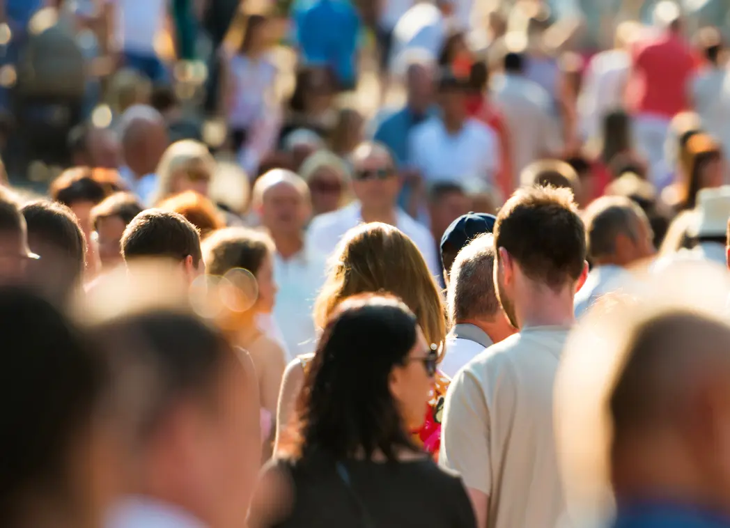 Crowd of people walking in a city street